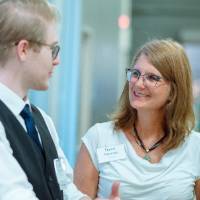 A student explaining something to a guest at the Engineering Design Project Preview